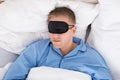 Man Sleeping On Bed Wearing Eyemask Royalty Free Stock Photo