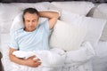 Man sleeping on comfortable pillow in bed