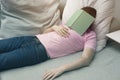 Man sleeping on couch with book on his head Royalty Free Stock Photo