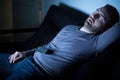 Bored man sleeping and watching tv at night Royalty Free Stock Photo