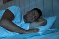 Man sleeping on electric heating pad in bed at night Royalty Free Stock Photo