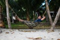 Man Sleeping on a Hammock or a net near on a Beach Royalty Free Stock Photo