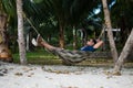 Man Sleeping on a Hammock or a net near on a Beach Royalty Free Stock Photo