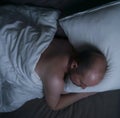 Man sleeping in his bed at night