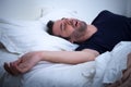 Man sleeping in his bed and snoring Royalty Free Stock Photo