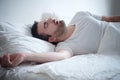 Man sleeping in his bed and snoring loudly Royalty Free Stock Photo