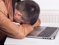 Man sleeping over laptop Royalty Free Stock Photo