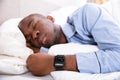 Man Sleeping With Smart Watch In His Hand Royalty Free Stock Photo