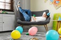 Man sleeping on sofa in room after party Royalty Free Stock Photo