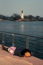 Man sleeping under Lord Shiva`s feet