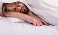 Man sleepy drowsy unshaven bearded face covered with blanket having rest. Guy lay under white bedclothes. Fresh