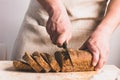 A man slices large knife with fresh bread with golden crust. The concept of home baking cooking diet food without yeast.