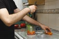 Man slicing carrots to put them in the mixing machine in the kitchen