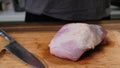 Man slicing pork meat on a table, conceptual idea. Healthy, preparing.