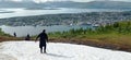 Snow on the top of the Mount Storsteinen in summer and panoramic view of Tromso city in Norway.