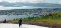 Snow on the top of the Mount Storsteinen in summer and panoramic view of Tromso city in Norway.