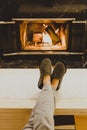 Man in slippers relaxing with his feet up - warm cozy cabin scene with a fireplace in the background. Royalty Free Stock Photo