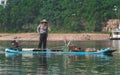 Man on the bamboo boat crossing Li River in Yangshuo