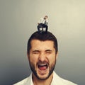 Man with small bored man on the head Royalty Free Stock Photo