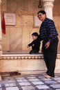 Man with a small boy watching rats at Karni Mata Temple, Deshnok, India