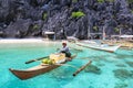 A man on small paraw at the sea of El Nido, Philippines