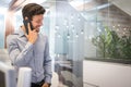 Man in smart casual business wear talking on mobile phone in modern office Royalty Free Stock Photo