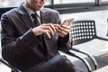 Man on smart phone - young business man in airport. Casual urban Royalty Free Stock Photo