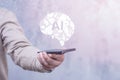 Man with smartphone displaying a holographic AI brain. Concept artificial intelligence and technology innovation