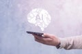 Man with smartphone displaying a holographic AI brain. Concept artificial intelligence and technology innovation
