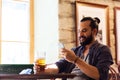 Man with smartphone drinking beer at bar or pub Royalty Free Stock Photo