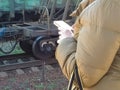 Man with a smartphone in his hands and in a jacket against the background of a train Royalty Free Stock Photo