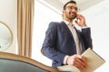 Man with a smartphone holding his notepad Royalty Free Stock Photo