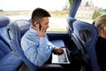 Man with smartphone and laptop in travel bus Royalty Free Stock Photo