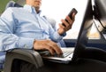 Man with smartphone and laptop in travel bus Royalty Free Stock Photo