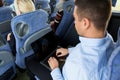 Man with smartphone and laptop in travel bus Royalty Free Stock Photo