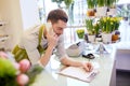 Man with smartphone making notes at flower shop Royalty Free Stock Photo