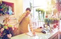 Man with smartphone making notes at flower shop Royalty Free Stock Photo