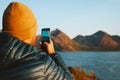 Man with smartphone taking photo in Norway travel lifestyle adventure vacations outdoor Royalty Free Stock Photo