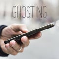 Man with smartphone and text ghosting