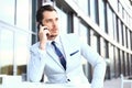 Man on smartphone - young business man talking on smart phone. Casual urban professional businessman using mobile cell Royalty Free Stock Photo