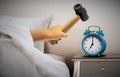 Man smashing alarm clock with sledge hammer Royalty Free Stock Photo