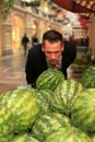 Man smelling watermellons in shopping-centre Royalty Free Stock Photo