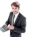 Man points to the calculator and looks at the camera Royalty Free Stock Photo