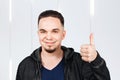 Man smiles and show thumbs up, dressed in hoody Royalty Free Stock Photo