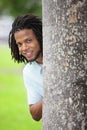 Man smiling from behind a tree Royalty Free Stock Photo