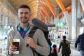 Man smiling in crowded airport Royalty Free Stock Photo