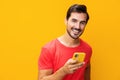 Man smiling cyberspace yellow phone copy smartphone studio happy portrait communication mobile phone space Royalty Free Stock Photo