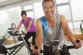 Man smiling and exercising on the exercise bike