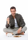 Man smiling and holding a coin Royalty Free Stock Photo