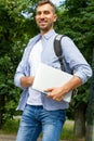 Man Smiling and holding a laptop in his hands. Royalty Free Stock Photo